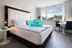 a bedroom with a bed with a free minder sign on it at INNSiDE by Meliá Aachen in Aachen