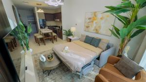 a bedroom with a bed and a living room at Skyline Dream - 1 BHK - Burj and Canal views in Dubai