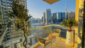 a balcony with a view of a city skyline at Skyline Dream - 1 BHK - Burj and Canal views in Dubai