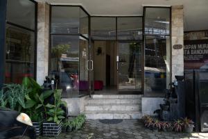 a building with glass doors and stairs in front at WABS Syariah in Bandung