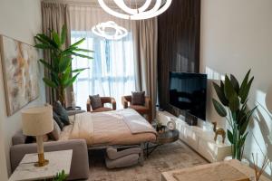 a bedroom with a bed and a tv in a room at Skyline Dream - 1 BHK - Burj and Canal views in Dubai