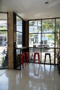 a room with a table and some red stools at WABS Syariah in Bandung