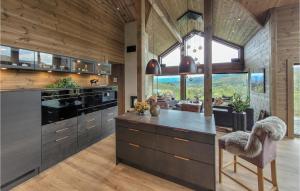 a kitchen with a large island with a counter top at Awesome Home In Norheimsund With Sauna in Norheimsund