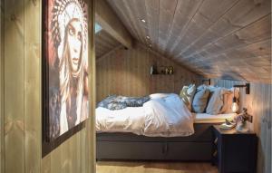 a room with a bed with a painting on the wall at Awesome Home In Norheimsund With Sauna in Norheimsund