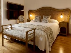 a bedroom with a large bed and a chair at CASA RECTORAL DE SAN EUSEBIO in Ourense +106 photos