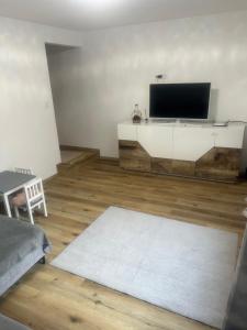 a living room with a flat screen tv on the wall at Ferienhaus im Schwarzwald in Pforzheim