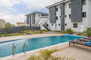 a swimming pool in front of a building at Clay House by Husk Collection in Abuja
