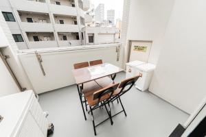 a room with a table and chairs on a balcony at TOKYO ICHIBAN SHINJUKU in Tokyo