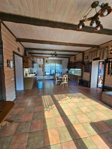a large living room with a wooden ceiling at L - Hutir in Mykulychyn