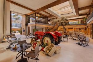 a restaurant with a red tractor in the middle of a room at Six Senses Ibiza in Portinatx