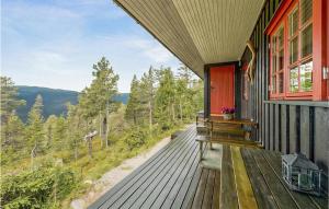 a house with a deck with a view of the mountains at 3 Bedroom Amazing Home In Eggedal in Eggedal +7 photos
