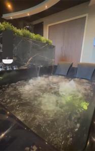 a conference room with a hot tub with chairs at Escapade 007 Refuge d Agent in Blois