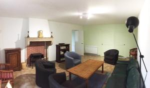 a living room with a couch and chairs and a fireplace at Grande Gte Du Chteau Des Moriers Fleurie in Fleurie