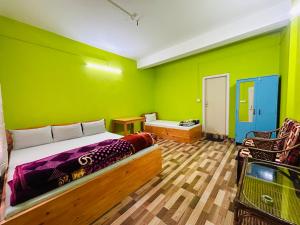 a bedroom with a bed and a green wall at Kalden Homestay in Dirang Dzong