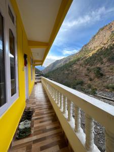 a balcony with a view of the mountains at Kalden Homestay in Dirang Dzong