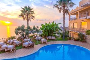 a resort with a pool and tables and chairs at Nettuno Hotel Palace in Belvedere Marittimo