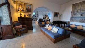 a living room with a blue couch and chairs at La Sirenetta Park Hotel in Stromboli