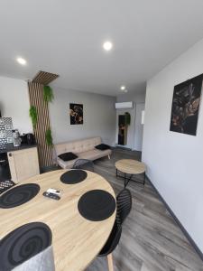 a living room with two tables and a couch at Cocon in La Souterraine