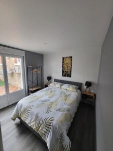 a bedroom with a bed with a zebra print sheets at Cocon in La Souterraine