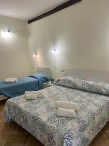 a bedroom with two beds with pillows on it at Villa Relais ALGHERO -Country Villa with Pool in Alghero +71 photos