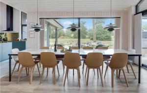 a dining room with a table and chairs at Nice Home In Nexø With Wifi in Neksø