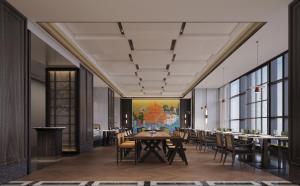 a dining room with a table and chairs at UrCove by HYATT Shantou Zhugang New Town in Shantou