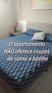 a sign on a bed in a bedroom at Riviera Apto 443 in Caldas Novas