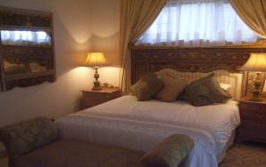 a bedroom with a bed and a chair and a window at Deck on Sea, 131 Nkwazi drive, Zinkwazi in Zinkwazi Beach