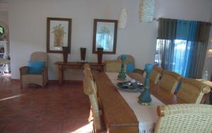 a living room with a wooden table and chairs at Deck on Sea, 131 Nkwazi drive, Zinkwazi in Zinkwazi Beach