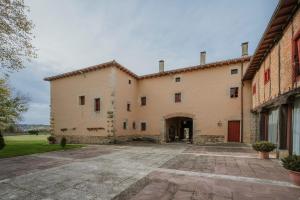 an exterior view of a large building with a courtyard at La Era 2 in Olmos de Ojeda