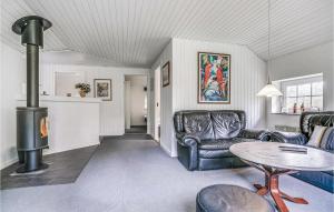 a living room with a couch and a wood stove at Holiday Home Nørballevej Blåvand I in Ho +30 photos