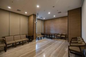 a conference room with a long table and chairs at 2BR Luxury Condo with 10Ha garden di Marigold BSD in Lengkong-kulon +87 photos