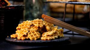 a pile of waffles on a plate with a spatula at Résidence Kaliopé in Le Lavandou +62 photos