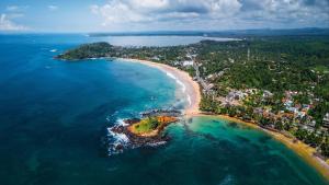 an aerial view of a beach and the ocean at Weligama Bay Eco Villa in Weligama
