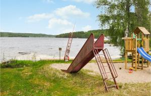 a playground with a slide and a ladder next to the water at Stunning Home In Skillingsfors in Gryttved