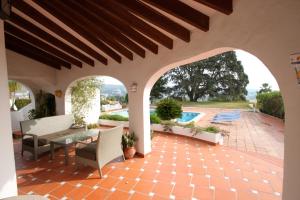 モライラにあるEl Barraco - sea view villa with private pool in Morairaの屋外パティオ(テーブル、椅子付)、プールが備わります。