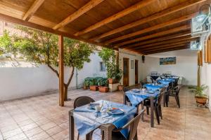 a restaurant with blue tables and chairs on a patio at La Saracina in Presicce