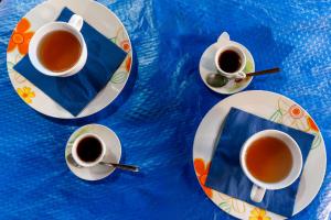 a table with two cups of tea on plates at La Saracina in Presicce +62 photos