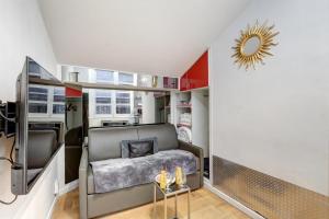 a small room with a bed and a table at Paris Marais Tiny MERRISAS in Paris