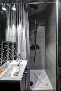 a bathroom with a sink and a shower and a tub at Paris Marais Tiny MERRISAS in Paris +1 photo