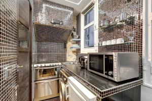 a kitchen with a counter with a microwave at Paris Marais Tiny MERRISAS in Paris