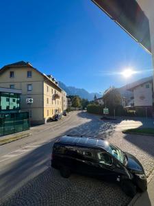 a black car parked on the side of a street at Ferienwohnung Steinlicht in Lienz