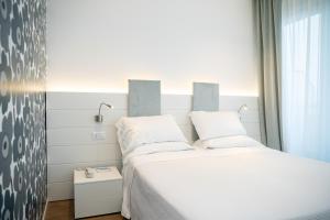 A bed or beds in a room at Hotel Majestic
