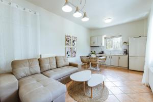 a living room with a couch and a table at Elafonisi - Cretan Serenity - Private Pool in Elafonisi