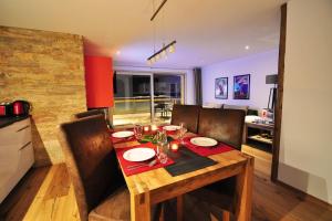 a wooden table with chairs and a dining room at Comfort apartment in Zermatt