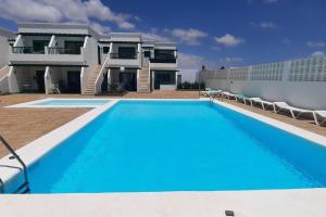 a large swimming pool in front of a house at Puerto del Carmen, Near Beach, Fast wifi, Pool in Puerto del Carmen