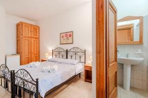 a bedroom with a bed and a sink at La Saracina in Presicce