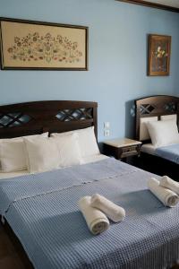 a bedroom with two towels on a bed at Vatellis Villas in Patitiri