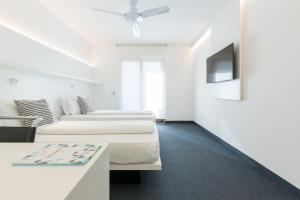 Ένα ή περισσότερα κρεβάτια σε δωμάτιο στο Hotel Santoni Freelosophy ***