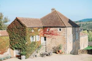 a large brick building with ivy on it at Château de Pierreclos in Pierreclos